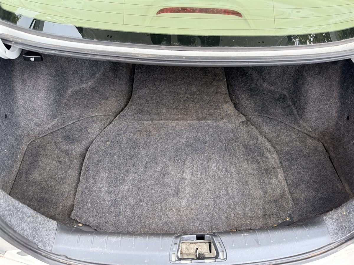 The same trunk after detailing: floor carpet back in place and vacuumed clean, with all debris removed
